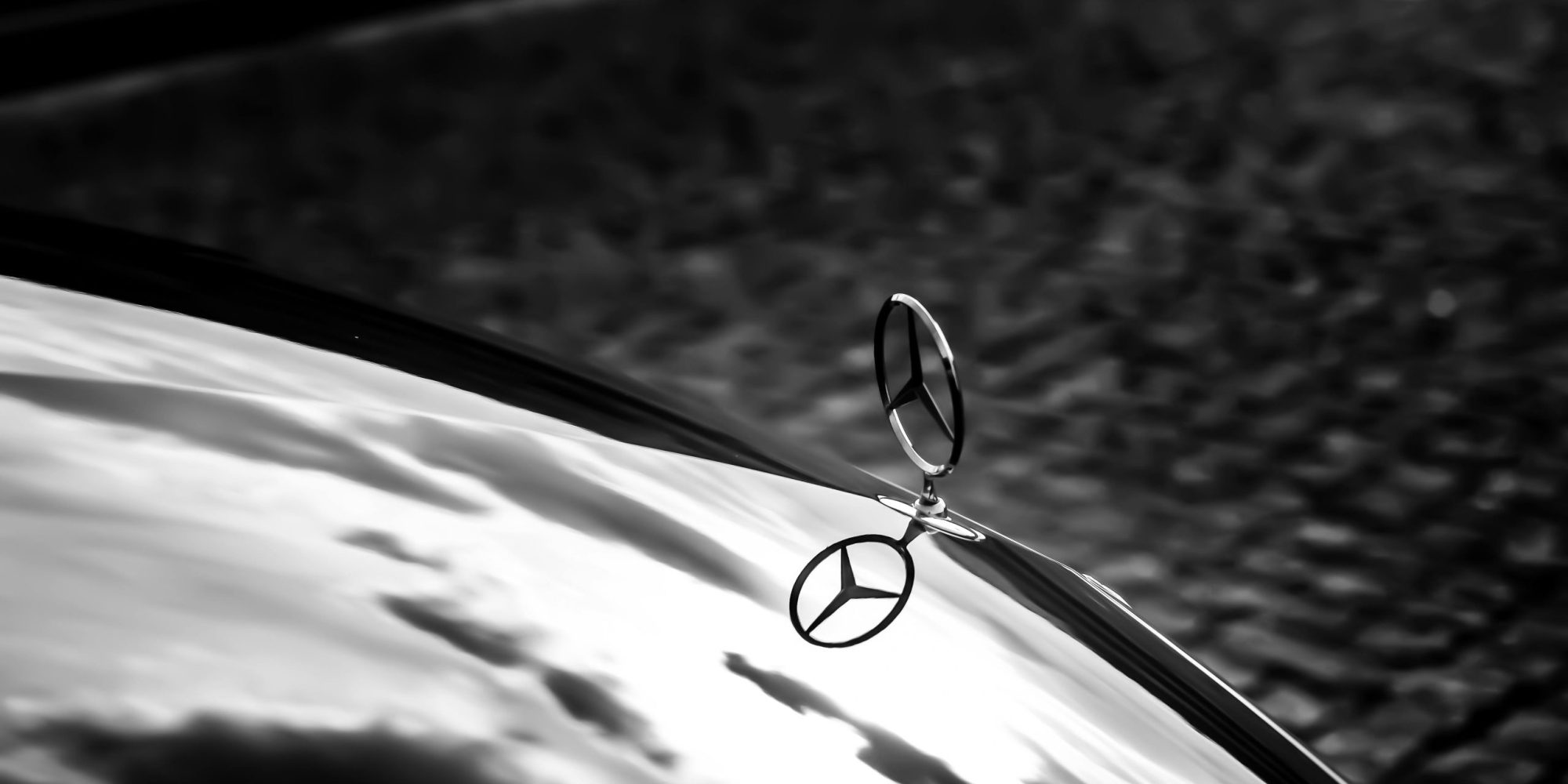 Elegant black and white photograph of a Mercedes hood by Pixabay