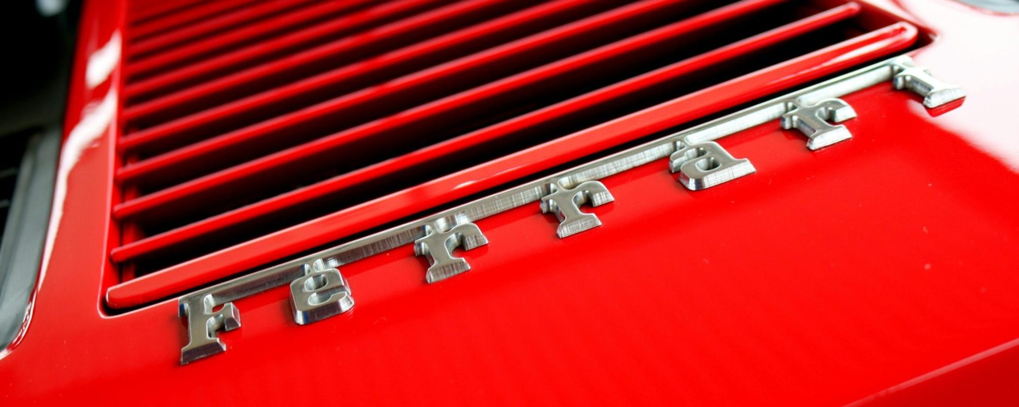 Detailed view of red Ferrari grille. - Mat Brown. Ferrari Wheel Spacers